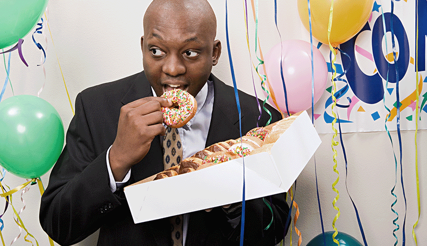 Business Man Eating Doughnuts in Office