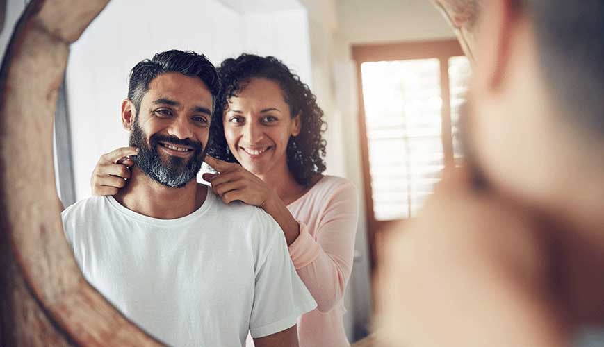 Couple Looking in Mirror, Thinking About Health