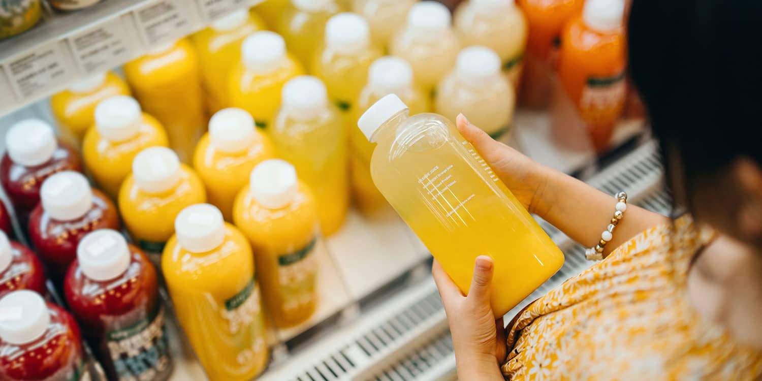 Refrigerator shelf stocked with functional drinks such as prebiotic soda, protein shakes, and electrolyte beverages