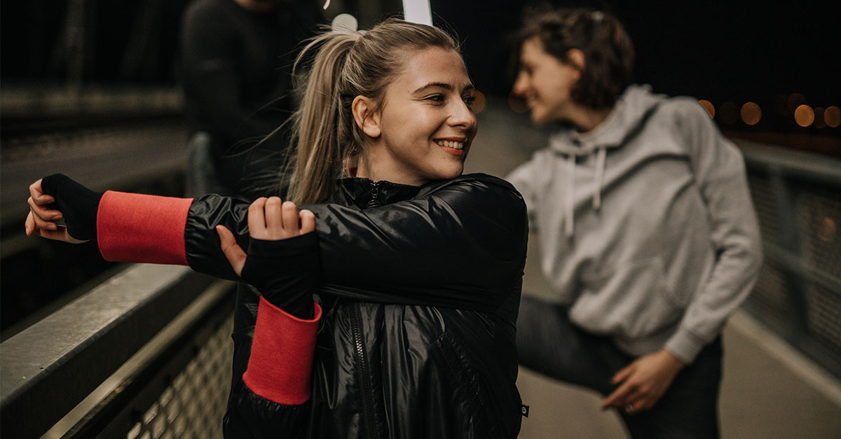 Runners warming up before a turkey trot to avoid injury